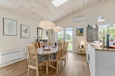 a kitchen and dining room with a table and chairs at JB165-Fjerritslev-Ostersvej-16 in Fjerritslev