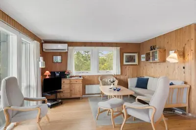 a living room with a couch and a table at JB115-Fjerritslev-Blabaerstien-9 in Fjerritslev