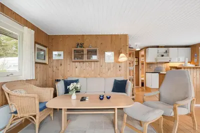 a living room with a couch and chairs and a table at JB115-Fjerritslev-Blabaerstien-9 in Fjerritslev