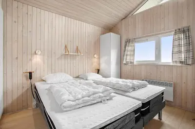 a bedroom with two beds and a window at JB705-Frostrup-Svenstibakkevej-82 in Frøstrup