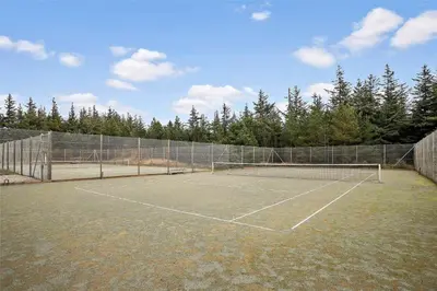 a tennis court with a net and some trees at JB158-Fjerritslev-Lynghojsletten-27 in Fjerritslev