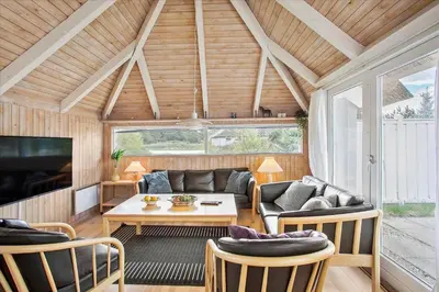 a living room with a couch and a table at JB158-Fjerritslev-Lynghojsletten-27 in Fjerritslev