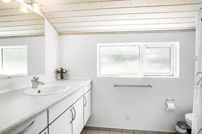 a white bathroom with a sink and two windows at JB243-Fjerritslev-Aspevej-1 in Fjerritslev