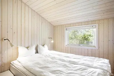 a white bed in a room with a window at JB243-Fjerritslev-Aspevej-1 in Fjerritslev