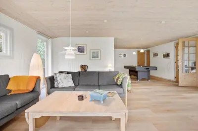 a living room with a couch and a coffee table at JB205-Fjerritslev-Tyttebaerstien-12 in Fjerritslev