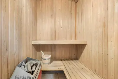 a small sauna with a basket of towels in it at JB205-Fjerritslev-Tyttebaerstien-12 in Fjerritslev