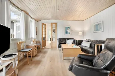 a living room with a couch and a table at JB205-Fjerritslev-Tyttebaerstien-12 in Fjerritslev
