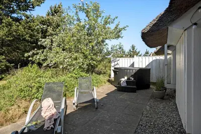 two chairs sitting on a patio next to a house at JB628-Fjerritslev-Lynghojsletten-49 in Fjerritslev