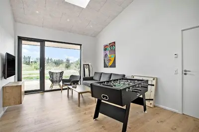 a living room with a ping pong table in it at JB141-Brovst-Kronvildtvej-86 in Brovst