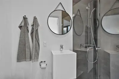 a bathroom with a shower and a sink and a mirror at JB141-Brovst-Kronvildtvej-86 in Brovst