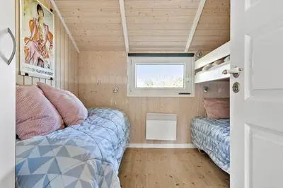 a small room with a bed and a window at JB303-Fjerritslev-Tyttebaerstien-50 in Fjerritslev