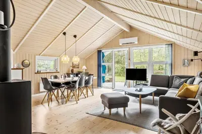 a living room with a couch and a table at JB303-Fjerritslev-Tyttebaerstien-50 in Fjerritslev
