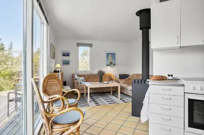 a kitchen and living room with a stove at JB1108-Frostrup-Strandvejen-67 in Frøstrup