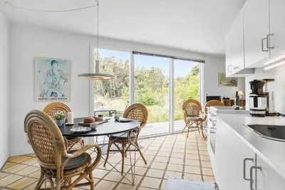 a kitchen and dining room with a table and chairs at JB1108-Frostrup-Strandvejen-67 in Frøstrup