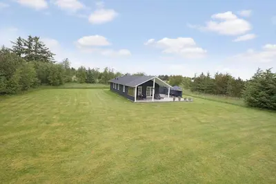 a large grassy field with a house in the middle at JB283-Frostrup-Andreas-Lassens-Vej-6 in Frøstrup