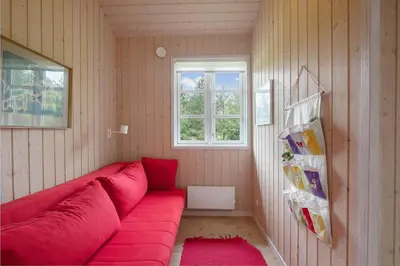 a red couch in a room with a window at JB283-Frostrup-Andreas-Lassens-Vej-6 in Frøstrup