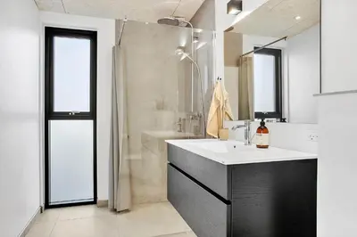 a white bathroom with a sink and a shower at JB190-Fjerritslev-Stenhusvej-34-B in Fjerritslev
