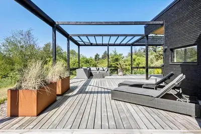 a wooden deck with lounge chairs on it at JB190-Fjerritslev-Stenhusvej-34-B in Fjerritslev