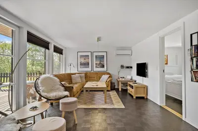 a living room with a couch and a table at JB908-Brovst-Kronvildtvej-190 in Brovst