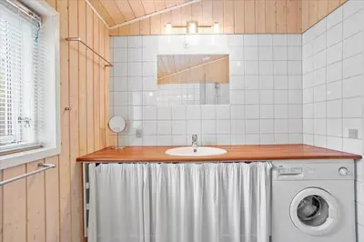 a bathroom with a sink and a washing machine at JB167-Fjerritslev-Revlingestien-83 in Fjerritslev