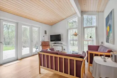 a living room with a couch and some windows at JB167-Fjerritslev-Revlingestien-83 in Fjerritslev
