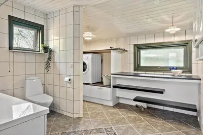 a bathroom with a sink and a toilet and a microwave at JB314-Fjerritslev-Tyttebaerstien-13 in Fjerritslev