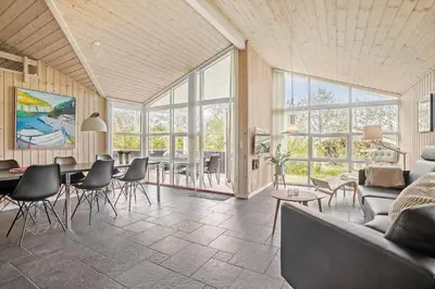 a living room with a couch and a table and chairs at JB888-Fjerritslev-Aspevej-15 in Fjerritslev