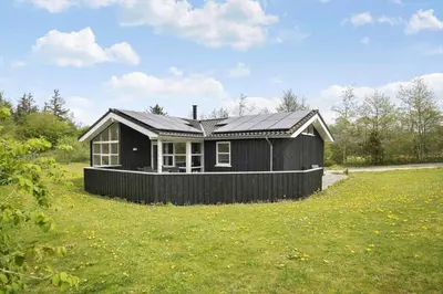 a black house with a solar roof on a field at JB888-Fjerritslev-Aspevej-15 in Fjerritslev