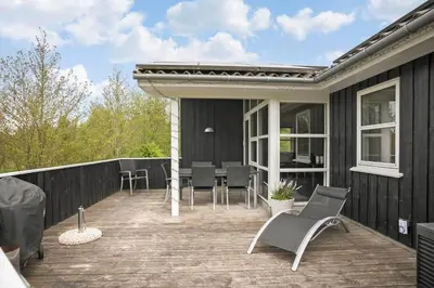 a deck with chairs and a table on a house at JB888-Fjerritslev-Aspevej-15 in Fjerritslev