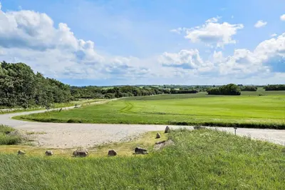 a dirt road in the middle of a green field at JB188-Fjerritslev-Kollerup-Klitvej-163 in Fjerritslev