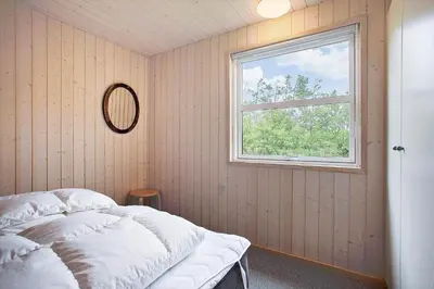 a bedroom with a white bed and a window at JB313-Fjerritslev-Fiskerstien-7 in Fjerritslev