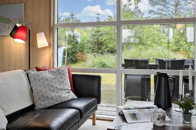 a living room with a couch and a large window at JB313-Fjerritslev-Fiskerstien-7 in Fjerritslev