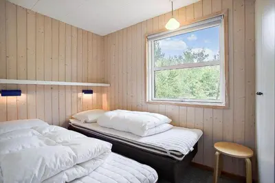 two twin beds in a room with a window at JB313-Fjerritslev-Fiskerstien-7 in Fjerritslev