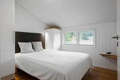 a bedroom with a white bed and a window at JB231-Fjerritslev-Poppelvej-2 in Fjerritslev