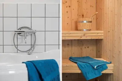 a bathroom with a shower and a tub with blue towels at JB231-Fjerritslev-Poppelvej-2 in Fjerritslev