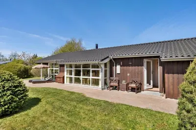 a home with a patio and a house at JB251-Fjerritslev-Egevej-5 in Fjerritslev