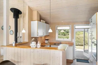 a kitchen with white cabinets and a sink and a window at JB251-Fjerritslev-Egevej-5 in Fjerritslev