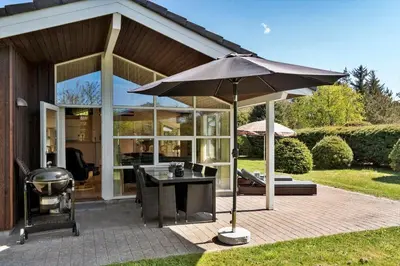 a patio with an umbrella and a grill at JB251-Fjerritslev-Egevej-5 in Fjerritslev