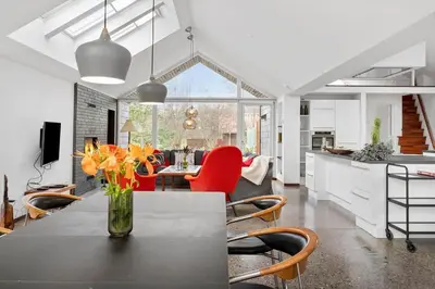 a kitchen and living room with a table and chairs at JB718-Fjerritslev-Tyttebaerstien-38 in Fjerritslev