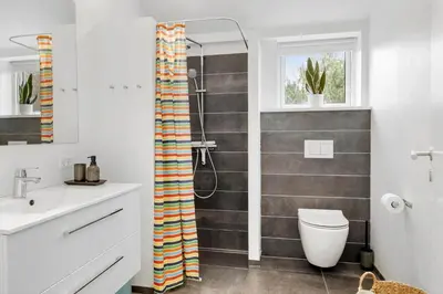 a bathroom with a shower with a toilet and a sink at JB718-Fjerritslev-Tyttebaerstien-38 in Fjerritslev