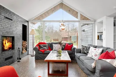 a living room with couches and a fireplace at JB718-Fjerritslev-Tyttebaerstien-38 in Fjerritslev