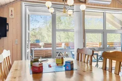 a dining room with a table with boxes on it at JB198-Fjerritslev-Tyttebaerstien-40 in Fjerritslev