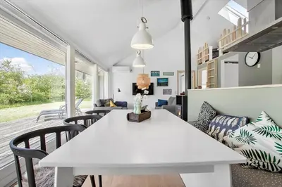 a living room with a white table and chairs at JB752-Brovst-Kronvildtvej-210 in Brovst