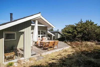 a wooden deck with a table and chairs on a house at JB138-Fjerritslev-C-J-Thaningsvej-3 in Fjerritslev