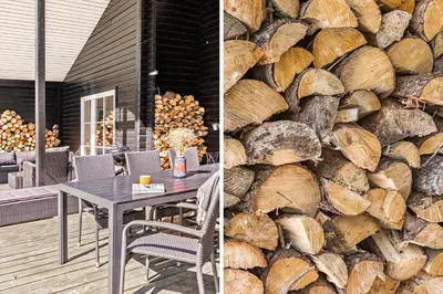 a table and chairs in front of a wall of logs at JB295-Brovst-Ildervej-7 in Brovst