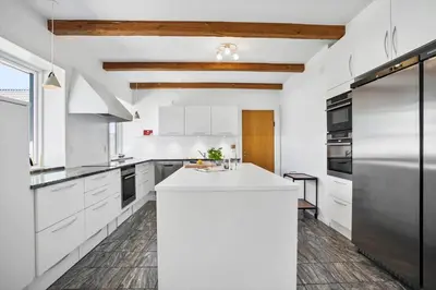 a kitchen with white cabinets and a white island at JB200-Fjerritslev-Udklitvej-168 in Fjerritslev