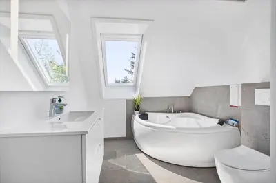 a white bathroom with a tub and a toilet at JB200-Fjerritslev-Udklitvej-168 in Fjerritslev