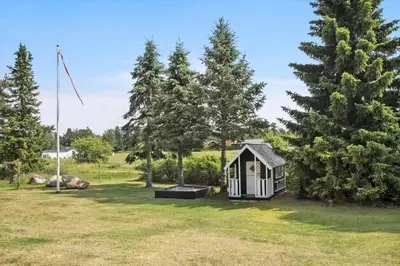 a small cabin in a field with trees at JB195-Fjerritslev-Bogevej-36 in Fjerritslev