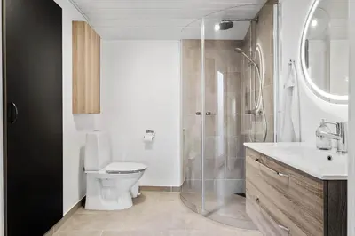 a bathroom with a toilet and a glass shower at JB195-Fjerritslev-Bogevej-36 in Fjerritslev
