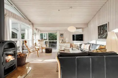 a living room with a couch and a fireplace at JB260-Fjerritslev-Blabaerstien-76 in Fjerritslev